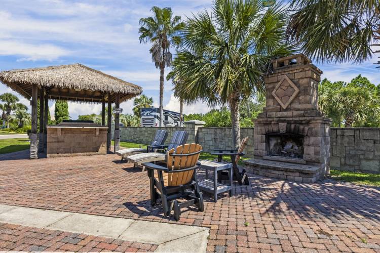 Outdoor fireplace at Buena Vista RV Resort outdoor fireplace wiht chairs around it at RV resort in orange beach alabama in winter weather